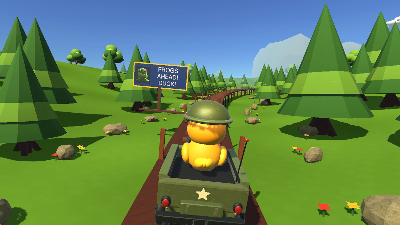 A large blue and gold Frogs Ahead sign with a frog portrait beside the track